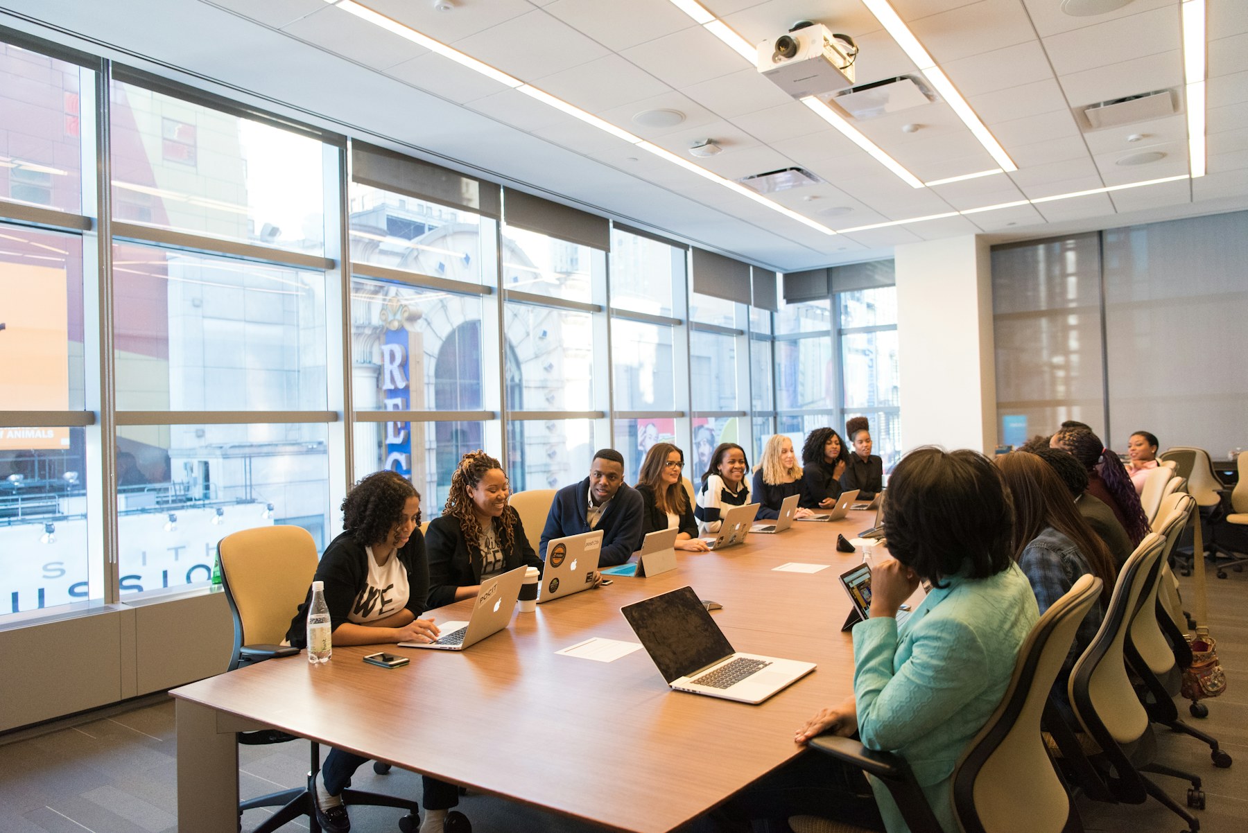 A consulting team collaborating around laptops in a workshop